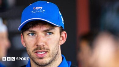 Close up of Alpine driver Pierre Gasly wearing a blue team baseball cap